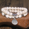 Witte kralenarmband met levensboom-bedel