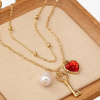 Ketting met harthanger en enkele parelhanger