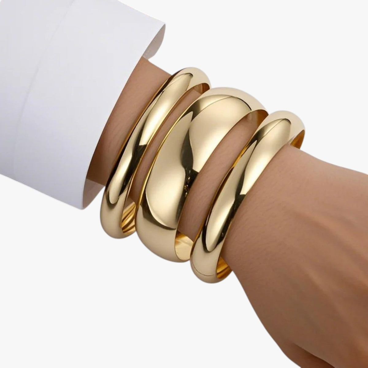 Set van drie brede bangles, goudkleurige afwerking