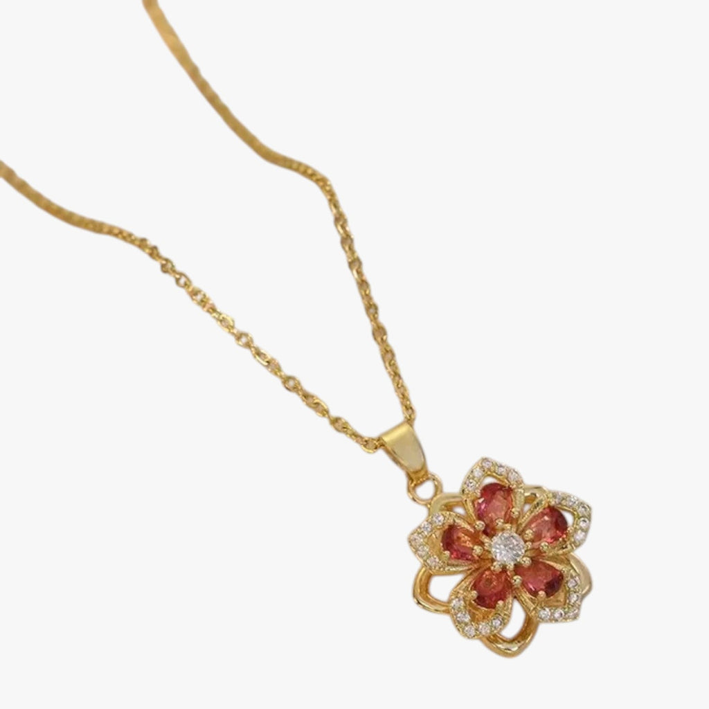 Goudkleurige ketting met ring en draaiende zirkonia bloem