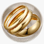 Set van drie brede bangles, goudkleurige afwerking