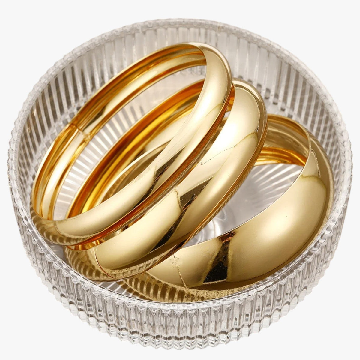 Set van drie brede bangles, goudkleurige afwerking
