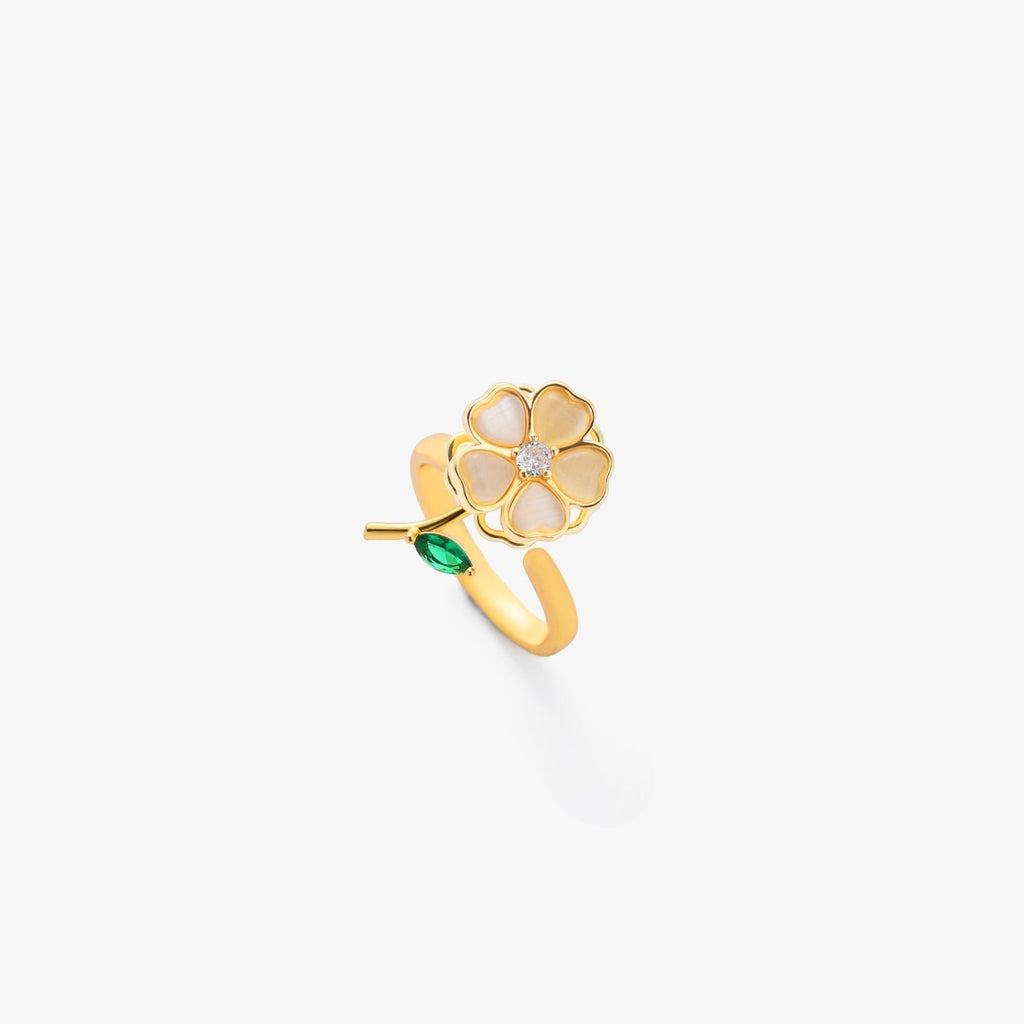 Verstelbare goudkleurige spinnerring met blad, bloem en smaragdlook