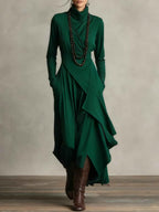 Gedrapeerde asymmetrische maxi-jurk met hoge hals en lange mouwen