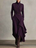 Gedrapeerde asymmetrische maxi-jurk met hoge hals en lange mouwen