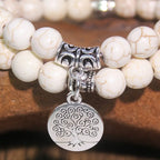 Witte kralenarmband met levensboom-bedel