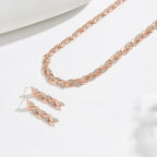 Roségoudkleurige set oorbellen en armband met bladschakels