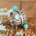Ambachtelijke zilverkleurige spinnerring met blad in aquamarijnlook