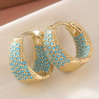 Goudkleurige oorringen met turquoise kralen