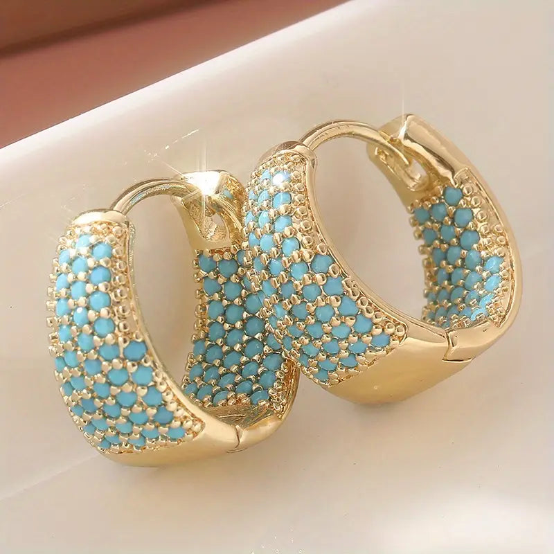 Goudkleurige oorringen met turquoise kralen