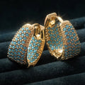 Goudkleurige oorringen met turquoise kralen