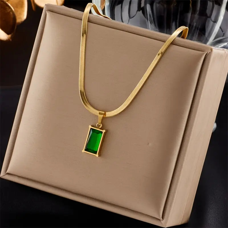 Set met slangenketting en oorbellen met groene steen in goudkleur