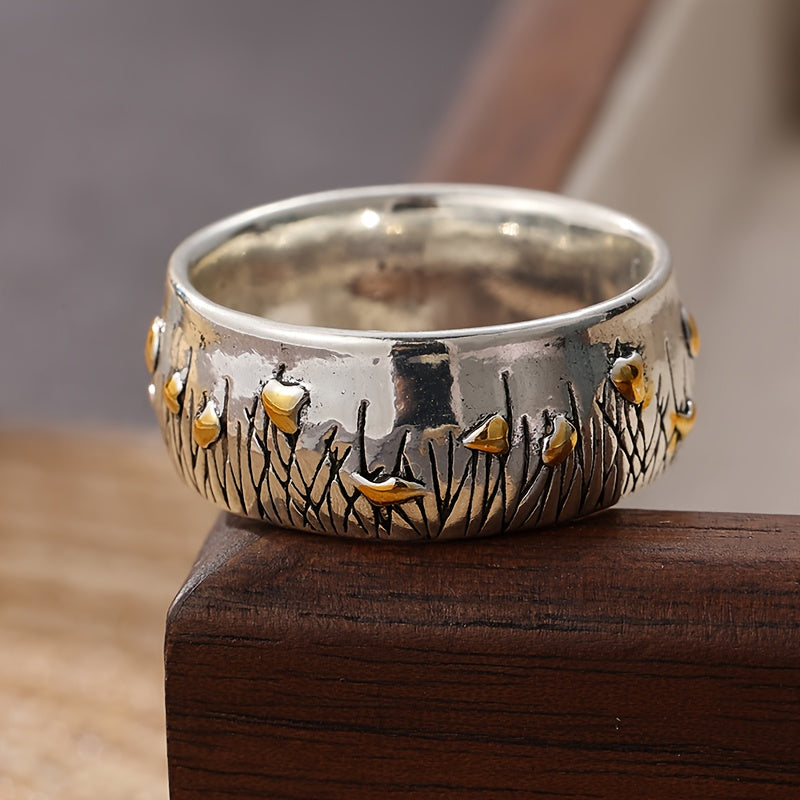 Retro tweekleurige ring in etnische stijl met bloem en gras