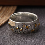 Retro tweekleurige ring in etnische stijl met bloem en gras