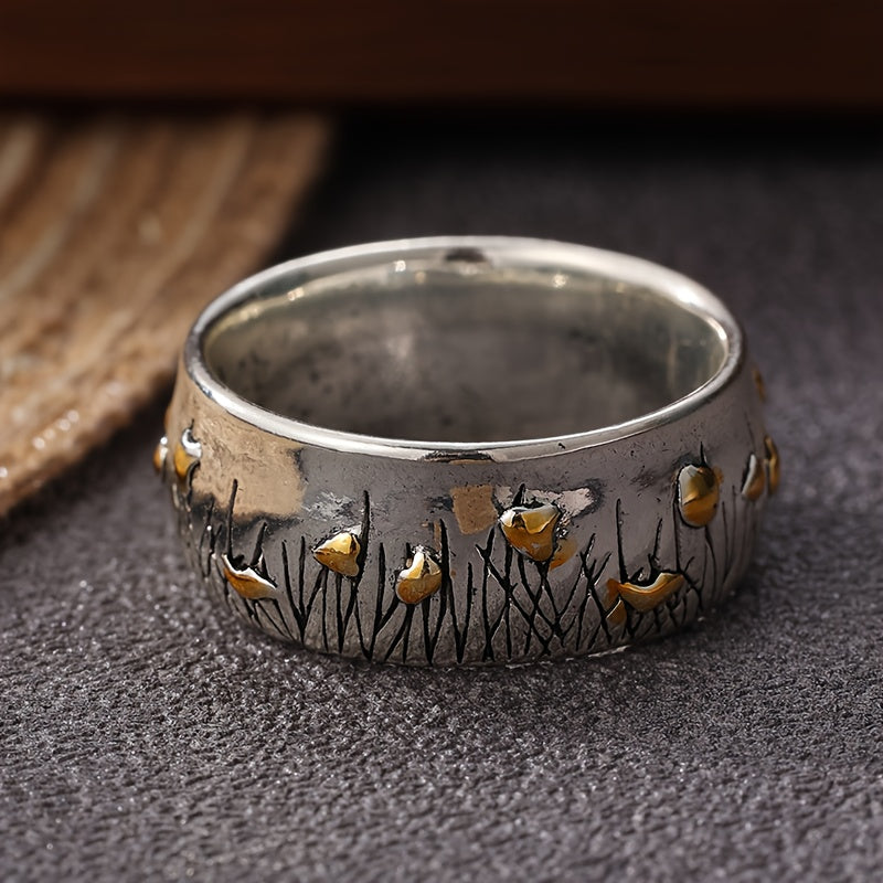 Retro tweekleurige ring in etnische stijl met bloem en gras