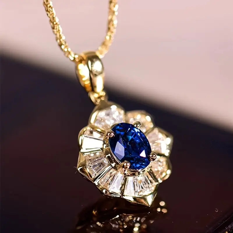 Ketting met sterrenstraalhanger en blauwe steen in goudkleur