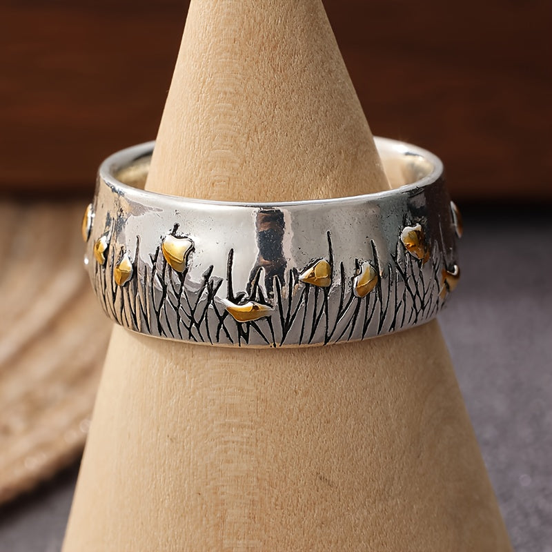 Retro tweekleurige ring in etnische stijl met bloem en gras