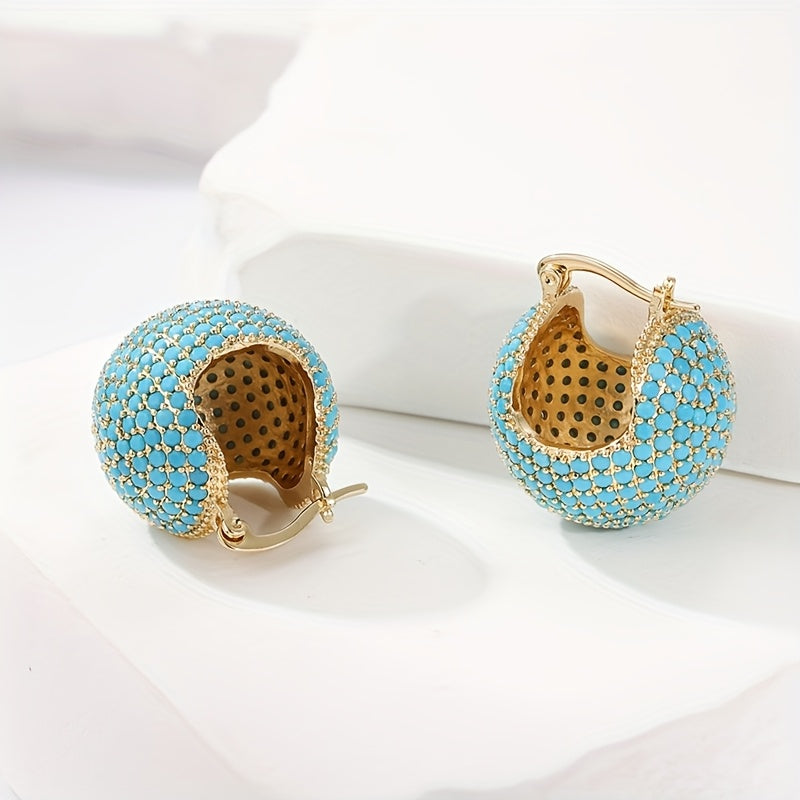 Retro goudkleurige oorringen met turquoise koepel