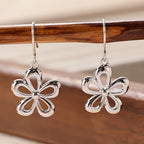 Vintage funky zilverkleurige oorbellen met bloemhanger