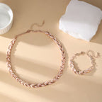Roségoudkleurige set ketting en armband met bladschakels