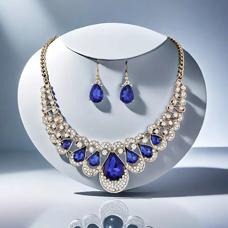 Set van slabketting en oorbellen met blauwe steen in goudkleur