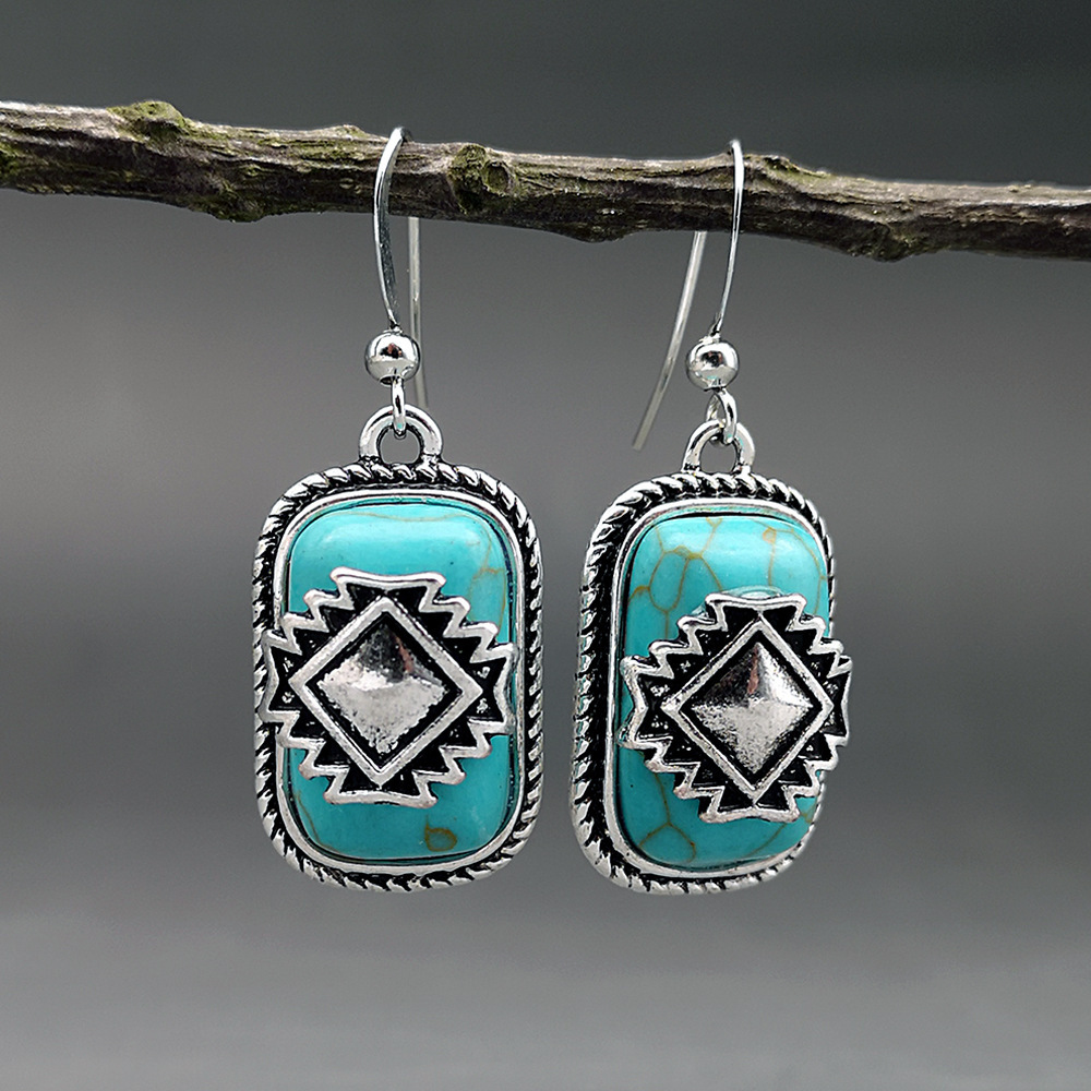 Etnische verzilverde oorbellen met turquoise steen