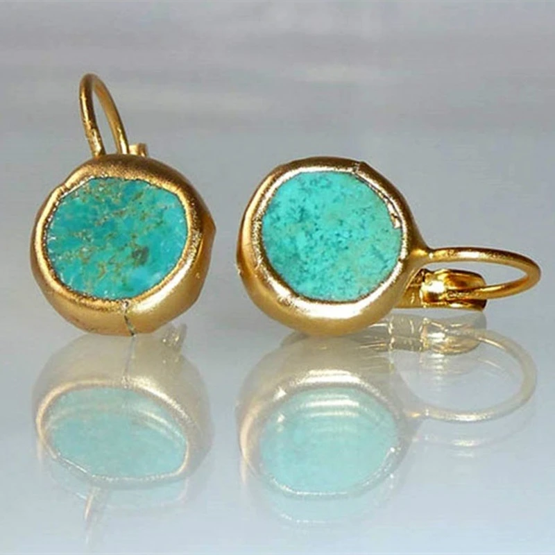 Goudkleurige oorbellen met omlijst turquoise schijfje