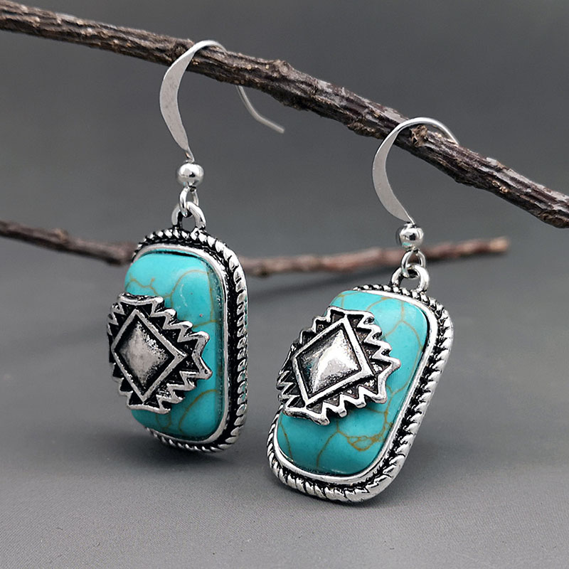 Etnische verzilverde oorbellen met turquoise steen