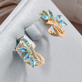 Blue Crystal Flower Stud Earrings in Gold Tone