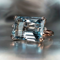 Emerald-Cut Blue Zirconia Ring with Crossed Silver-Tone Prongs