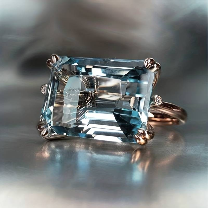 Emerald-Cut Blue Zirconia Ring with Crossed Silver-Tone Prongs