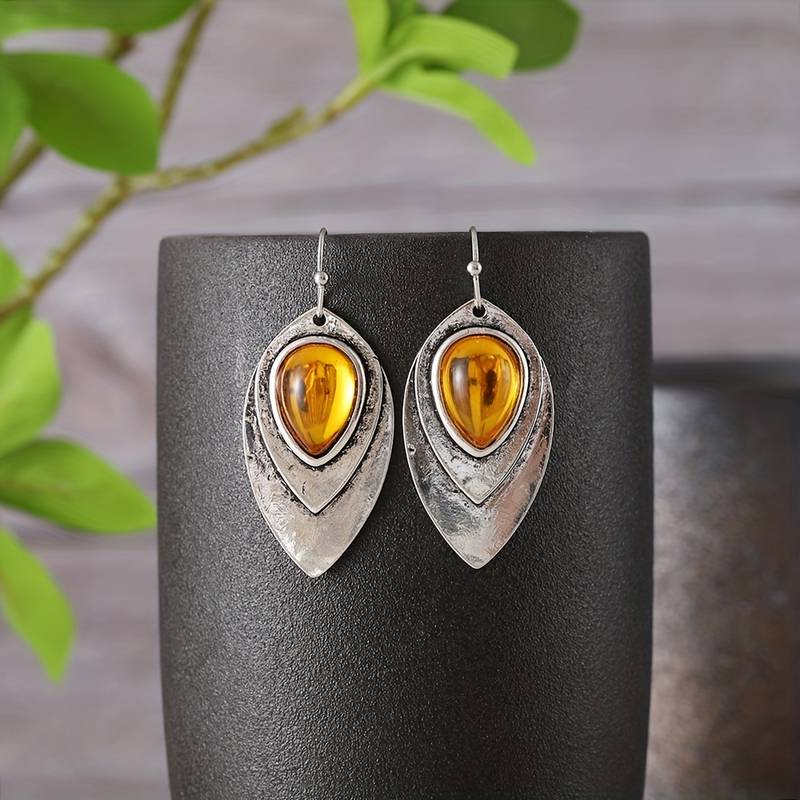 Vintage zilverkleurige oorbellen met oranje kristal