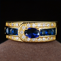 Gold-Tone Ring with Oval Blue Zirconia and Channel-Set Stones