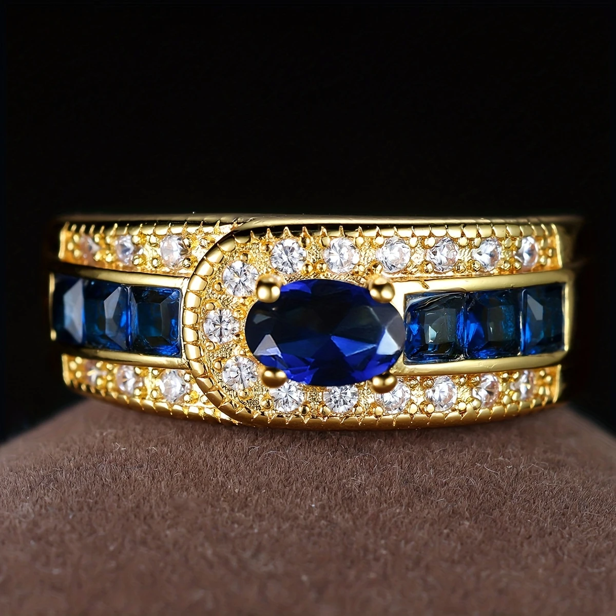 Gold-Tone Ring with Oval Blue Zirconia and Channel-Set Stones