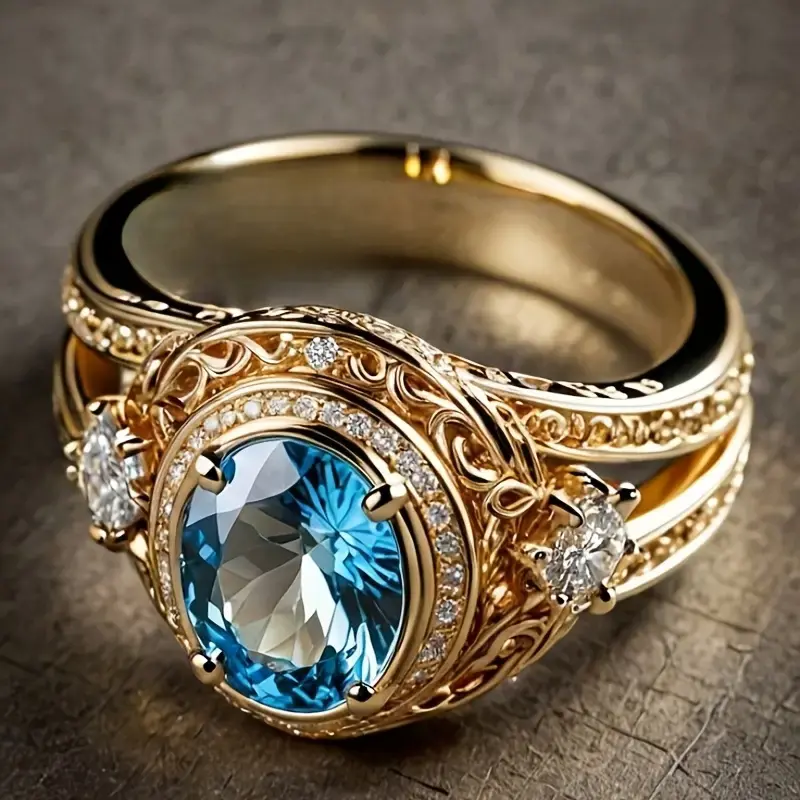 Stralende goudkleurige ring met lichtblauw kristal
