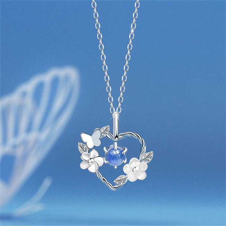 Zilverkleurige bloemenketting met hart van blauw kristal