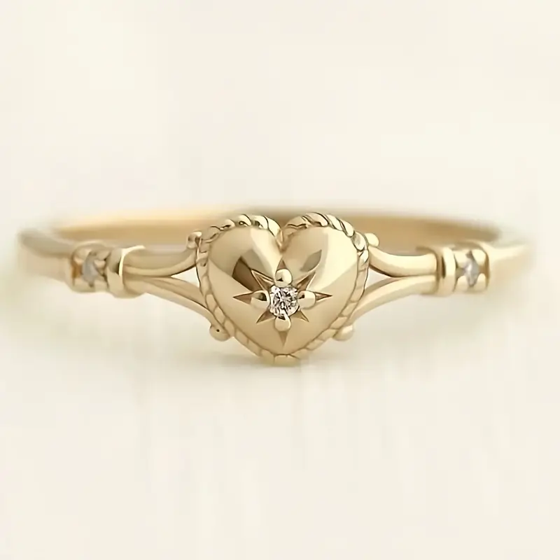 Goudkleurige ring met hart en ster