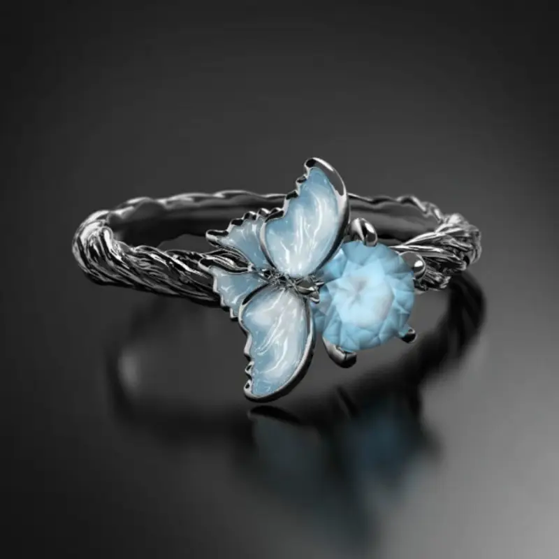 Zilverkleurige kristalring met blauwe bloesem