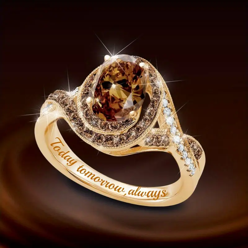 Ronde goudkleurige ring met rond en ovaal oranje glas en zirkonia