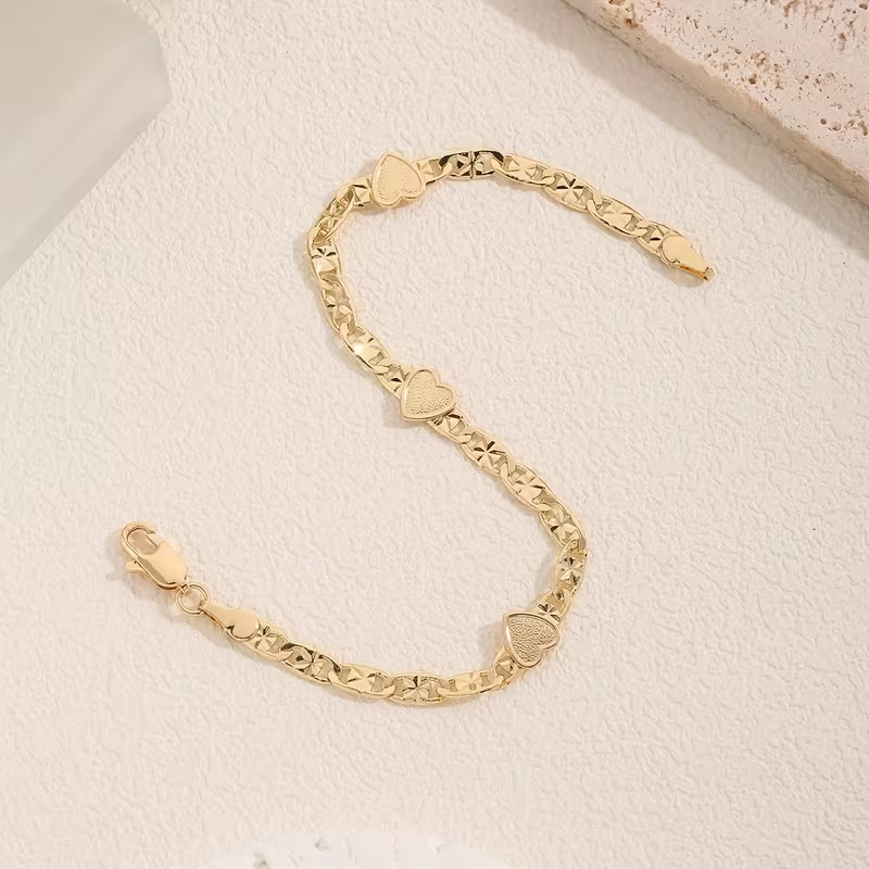Goudkleurige Cubaanse schakelarmband met hart