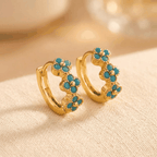 Vergulde oorringen met turquoise bloem