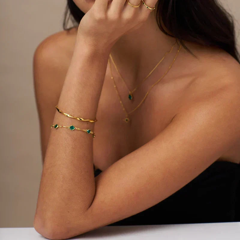 Schakelarmband met smaragdlook in goudkleur