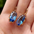Oorhangers met blauwe marquisesteen in goudkleur