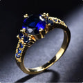 Gold-Tone Ring with Oval Blue Stone and Side Accents